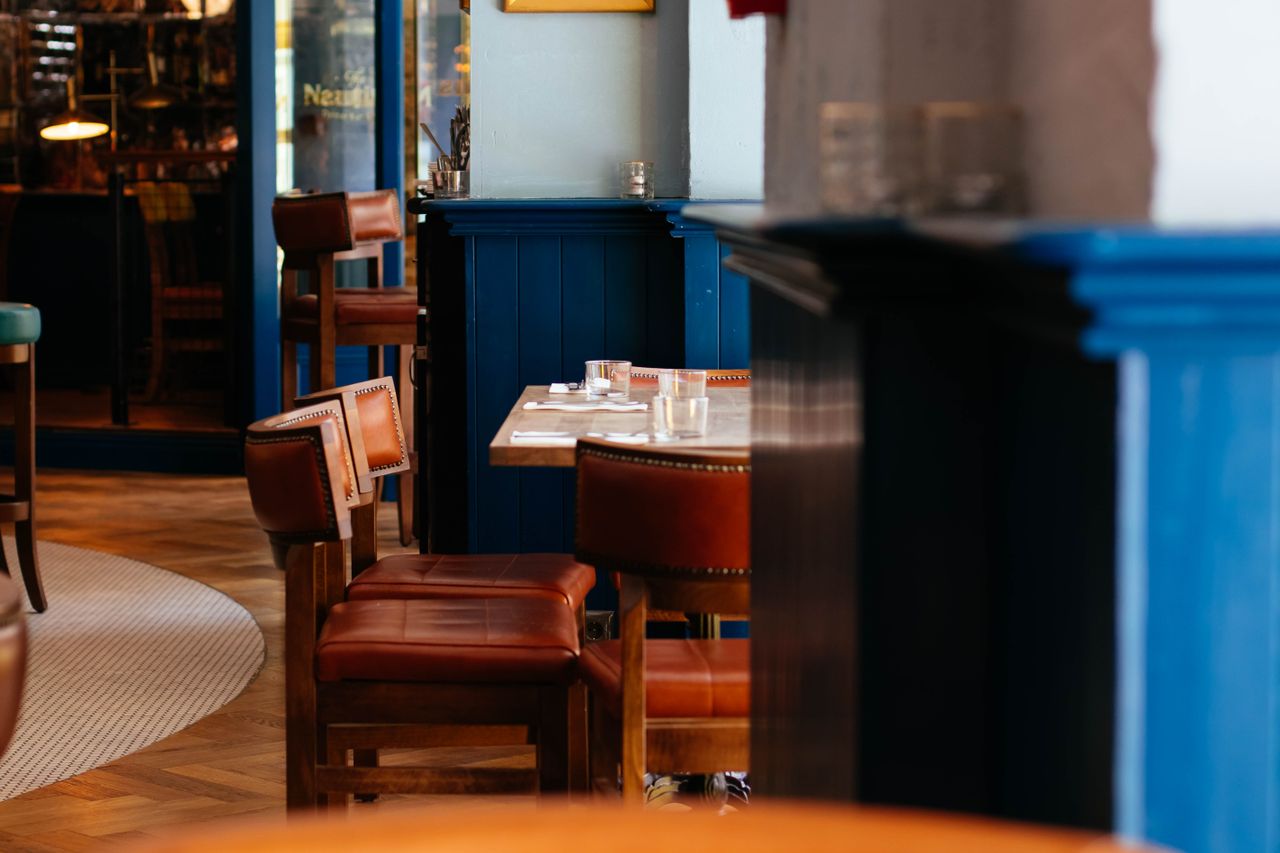 journey A stylish and modern restaurant interior with wooden furniture and blue accents.
